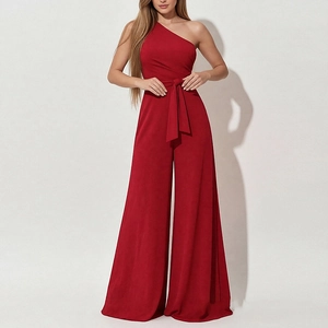 Detail of elegant dark red one-shoulder jumpsuit featuring a tied waist and wide-leg design