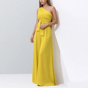 Detail of elegant one-shoulder yellow jumpsuit with matching tie waist and wide legs