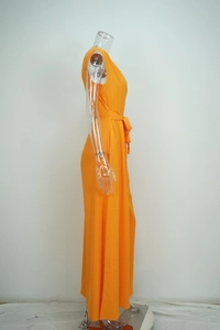 Detailed side view of a bright orange one-shoulder wide-leg jumpsuit with a waist tie belt