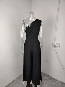 Detailed back view of a black one-shoulder wide-leg jumpsuit with elegant waist pleats