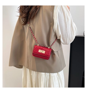 Macro shot of red chevron quilted mini bag with gold chain strap and turn-lock