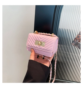 Detailed close-up of pink-purple quilted chain bag with gold twist lock and V-texture