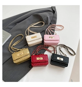 Detailed arrangement of five mini quilted leather crossbody bags with gold chain straps