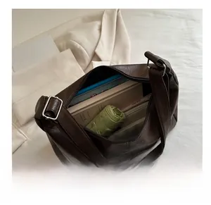Deep brown oversized tote bag in lychee leather showing spacious interior capacity