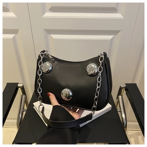 Close-up of black PU leather shoulder bag featuring silver metal rivets and chain strap