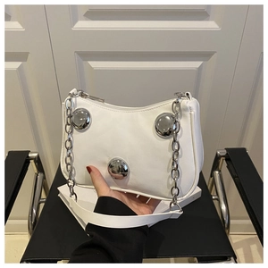 Close-up of white PU leather underarm bag featuring three semi-circular silver metal ornaments