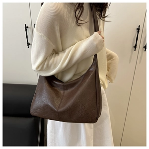 Detail of vintage dark brown crossbody bag with natural wrinkled leather texture