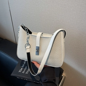 White textured shoulder bag with silver chain strap and metal swivel lock for women