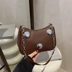 Brown leather crossbody bag with silver sphere hardware and stylish chain strap
