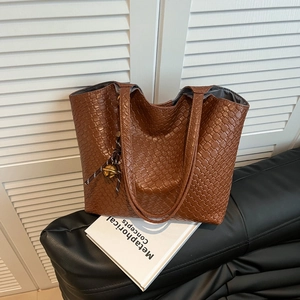 Brown woven tote bag for women with metallic ball charm and slim shoulder straps