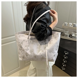 Close-up of romantic butterfly print on large white tote bag with long shoulder straps