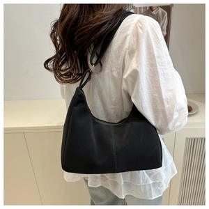Detailed back view of a black matte crescent hobo bag worn over the shoulder