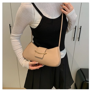 Detail of beige half-moon shoulder bag with premium synthetic leather and gold hardware