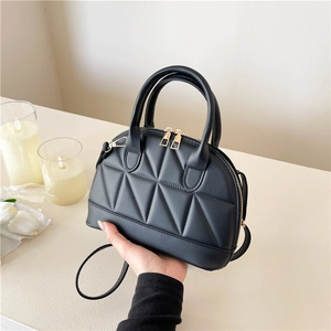 Borsa a mano nera trapuntata a conchiglia con motivo geometrico e dettagli dorati