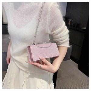 Elegant pink glitter clutch bag with silver chain strap shown in a modern lifestyle setting