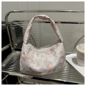 Detailed view of white jacquard shoulder bag with pink butterflies and silver metallic thread