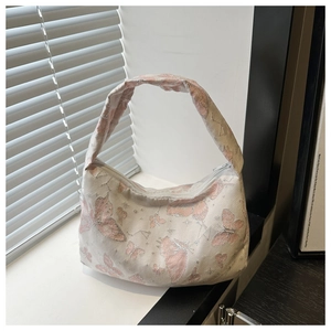 Close-up of pink butterfly jacquard fabric texture and zipper on the shoulder bag