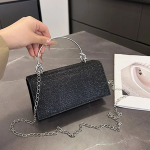 Elegant black sequin clutch bag with silver circular handle and metal chain strap