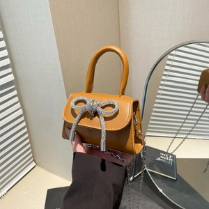 Brown mini handbag with oversized rhinestone bow and silver chain strap for women
