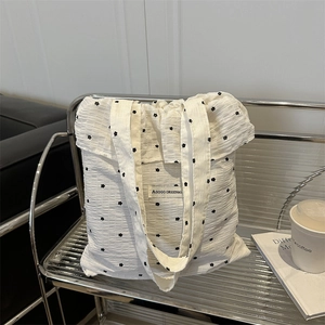 White fairy ruffle tote bag with black floral pattern and bubble pleated texture