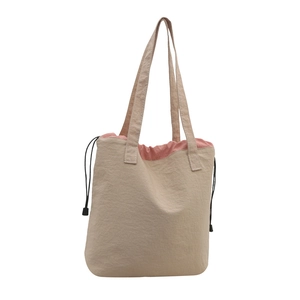 Women's vintage drawstring tote bag in beige and pink contrast colors with shoulder straps