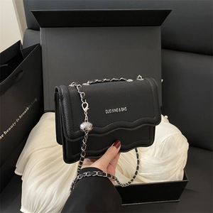 Litchi pattern leather square crossbody bag with wavy flap and silver chain strap