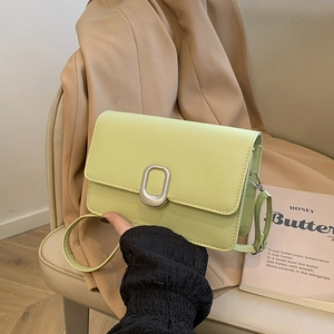 Minimalist pistachio green square crossbody bag with oval silver buckle and leather strap