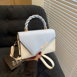 Fashionable blue and white contrast handbag with twisted handle and envelope flap