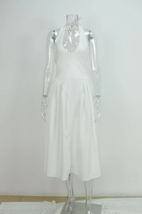 Detail of elegant white halter neck dress with deep V-neck and pleated waist design