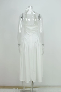 Detailed back view of white halter dress featuring invisible zipper and pleated waistline