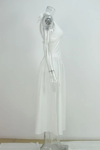 Side view of white halter neck dress on mannequin showing elegant silhouette and drape
