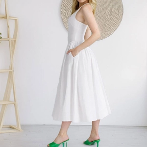 Elegant white V-neck sleeveless A-line midi dress with pockets and a high-waist silhouette