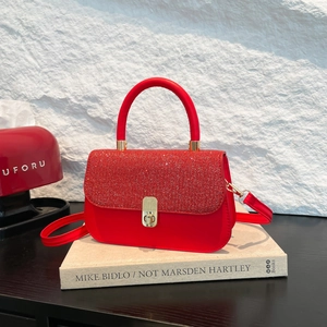 Elegant red contrast handbag with sequins and smooth leather featuring gold twist lock