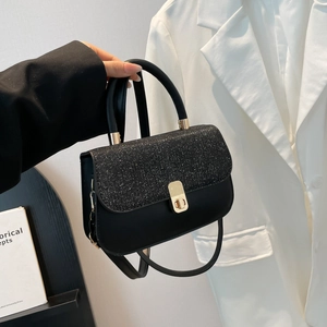 Chic black flap crossbody bag with glitter texture and gold metal buckle closure