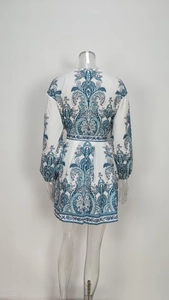 Detail view of the back of white paisley print mini dress with long lantern sleeves