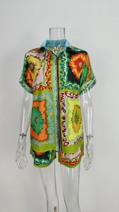 Detailed view of floral baroque print on two-piece short sleeve shirt and shorts set