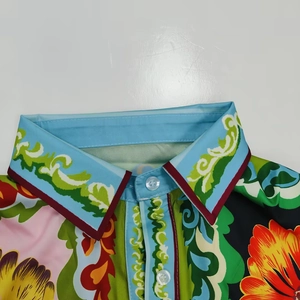 Detailed macro view of the lapel collar and baroque floral print on the casual shirt