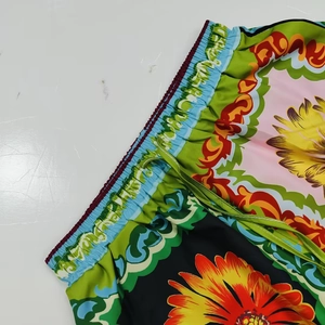 Detail of sunflower print shorts with elastic waistband and green drawstring closure