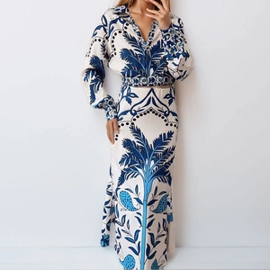 Elegant two-piece set for women featuring V-neck shirt and skirt with blue palm leaf prints