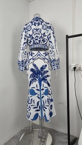 Detail view of the back of a blue and white printed two-piece long dress and top set