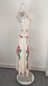 Detailed side view of ruffle floral print maxi skirt and tube top set for vacation
