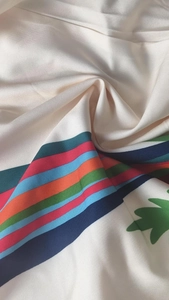 Close-up of elegant floral and striped textile fabric with soft pleated texture