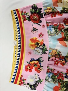 Detail shot of a vibrant floral and landscape print high waist skirt with hidden zipper