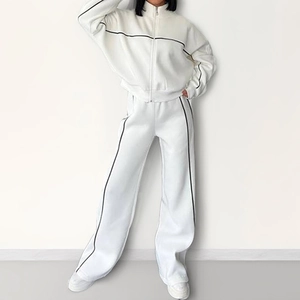 Women's white lounge tracksuit with black piping featuring zip-up jacket and wide-leg pants