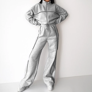 Women's grey two-piece tracksuit with black side stripes and zip-up drawstring hoodie