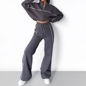 Women's dark gray athletic lounge set with zip jacket and wide-leg joggers in side view