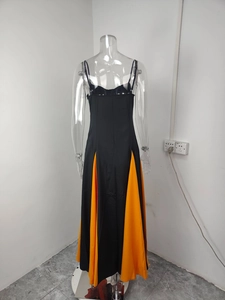 Detail of the back corset style lacing on the black and orange patchwork maxi dress
