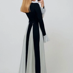 Elegant high-waist black maxi dress with grey pleated panels and flared sleeves