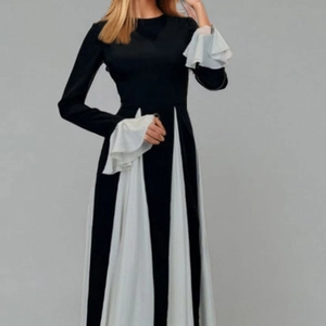 Elegant black and white contrast dress with flared layered sleeves and pleated waist