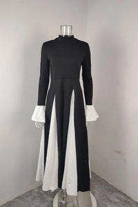 Detail view of contrast white pleated cuffs and skirt hem on black midi dress